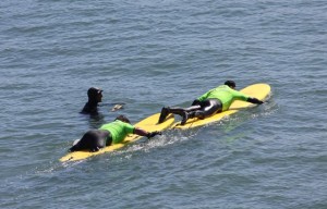 Operation-Surf-wounded-soldier-gets-tow-on-surfboard-by-Pam-Marino-Good-Neighbor-Stories